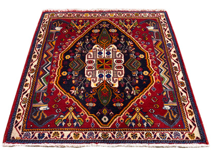Poshti rug (67×67 cm) in angled view: border, red center, dark blue