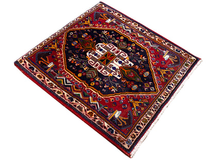 Square 70x67 cm rug: dark medallion with red border and ornamental trim