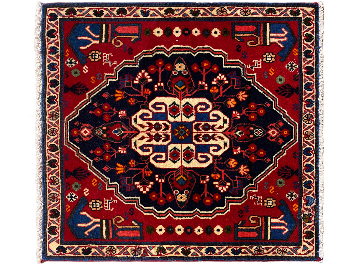 Red and dark blue rug with a large central ornament, square, 68x64 cm