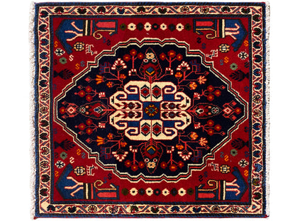 Red and dark blue rug with a large central ornament, square, 68x64 cm