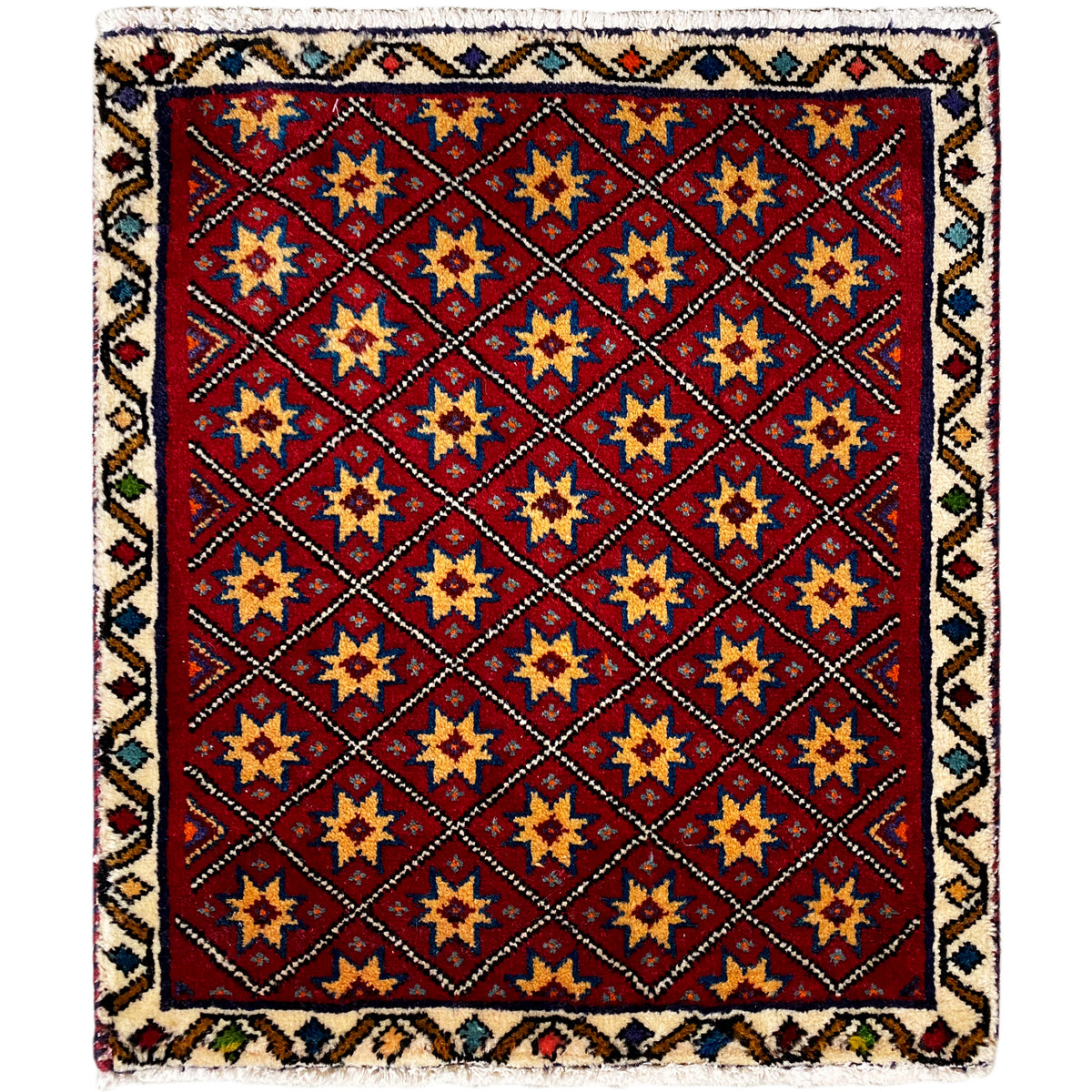 Square rug with a red background and a multicolored geometric star pattern